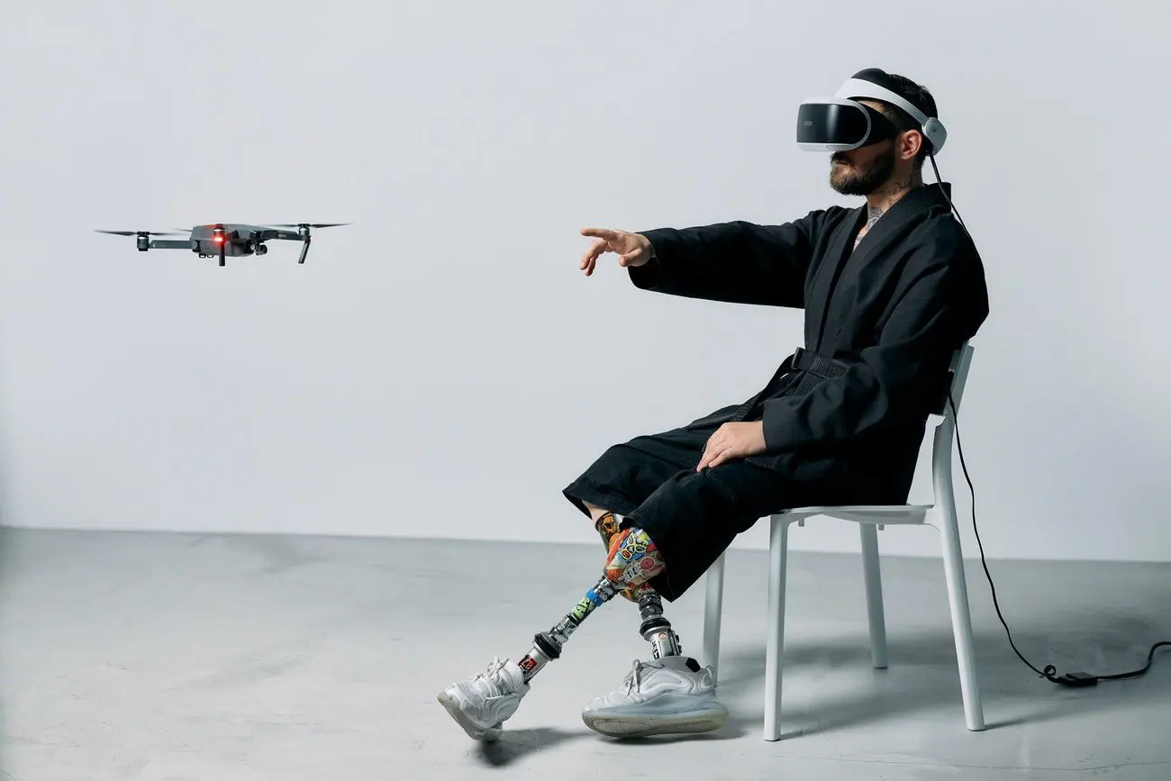 Man with a virtual reality headset steering a drone